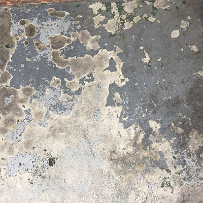 Cracking paint on concrete floor