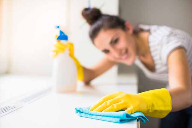 Woman cleaning windowsill